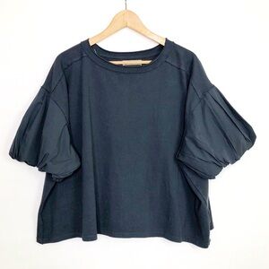 Free people with a free, gray, puffy sleeve oversize top